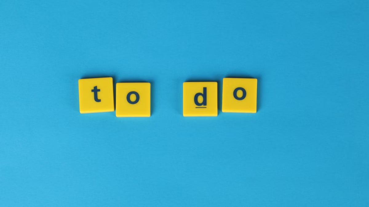 Yellow letter tiles spelling 'to do' against a vibrant blue background for organizational themes.